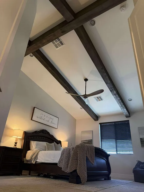 Crossed beams frame the primary bedroom ceiling