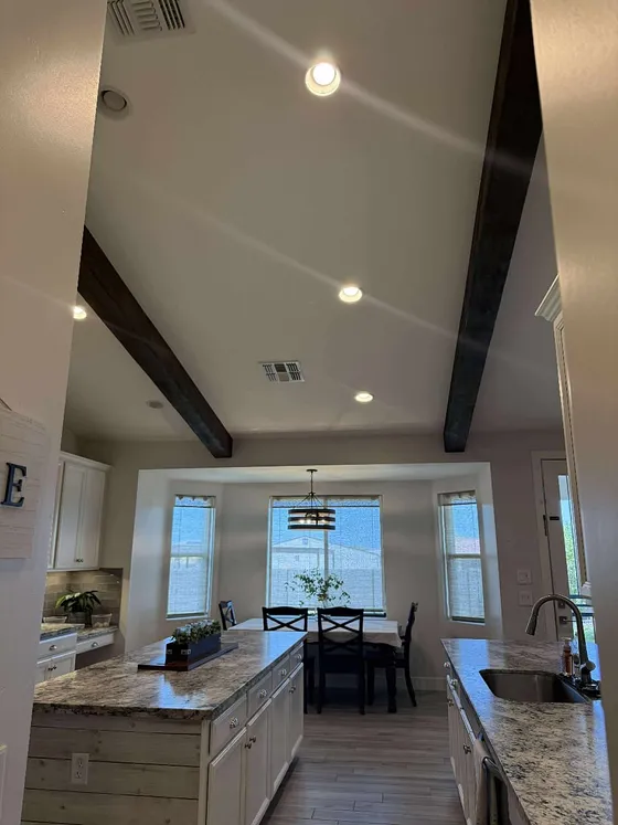 A single beam crosses the kitchen bay window