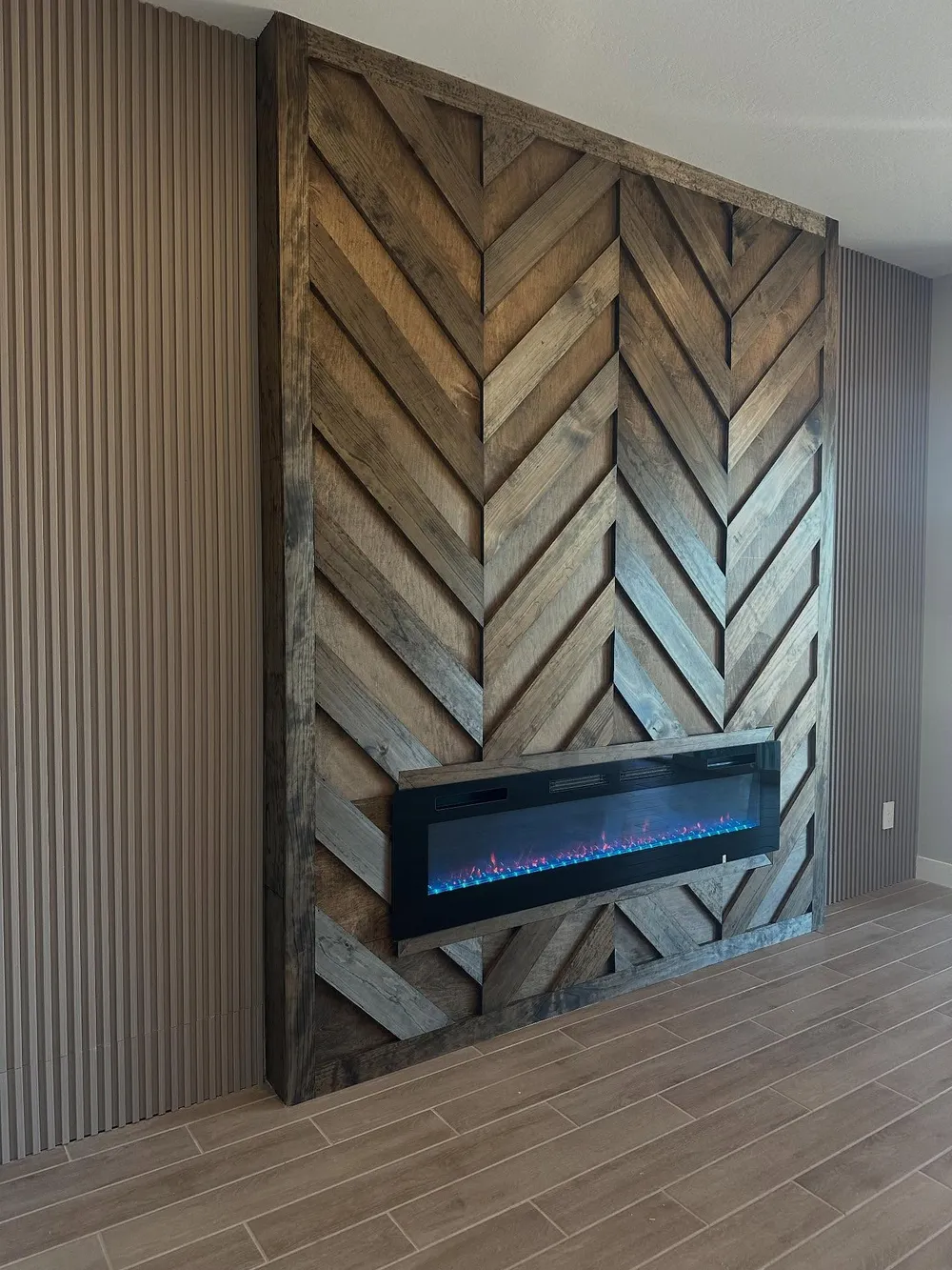 Herringbone fireplace wall in two tone stained wood