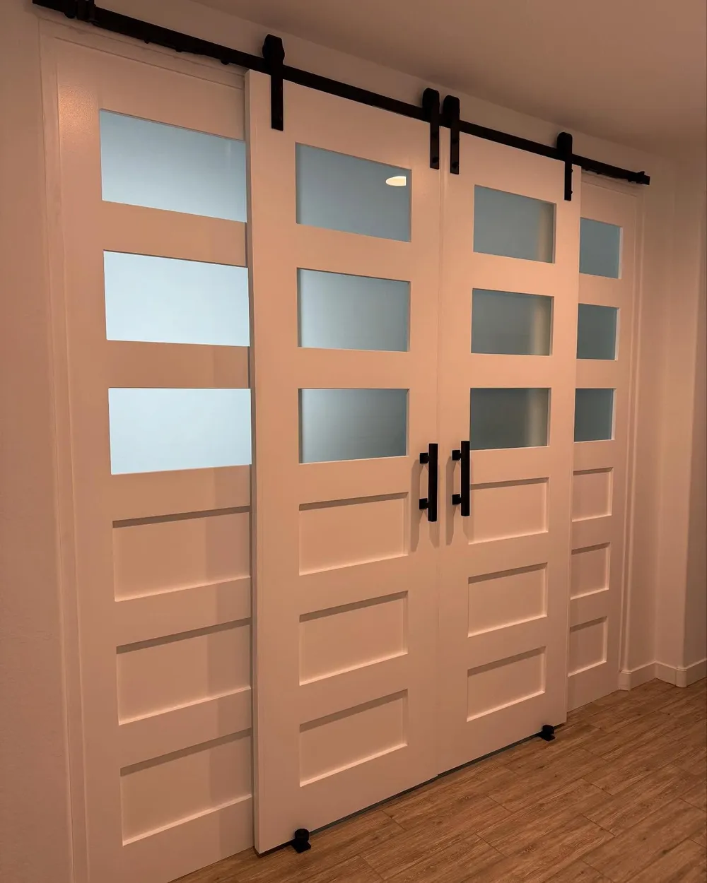 Bypass barn doors with frosted glass panes in soft white