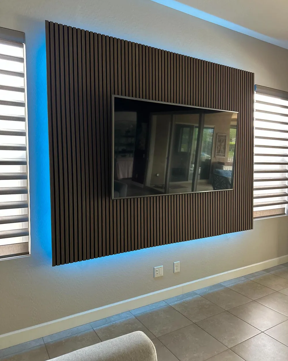 Wood slat media wall with blue backlighting