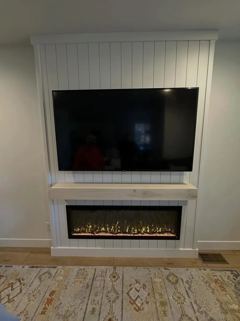 Whitewashed shiplap fireplace wall with floating pine mantel